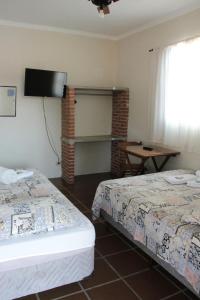 เตียงในห้องที่ Piccola Pousada