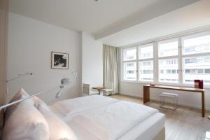 a bedroom with a white bed and white walls at Ellington Hotel Berlin in Berlin