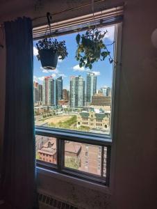 a window with a view of a city skyline at Stylish Downtown Calgary Home in Calgary