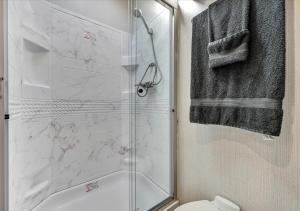 a bathroom with a shower and a toilet and a sink at Cozy 2-Guest RV on Nature Farm in Pine Grove