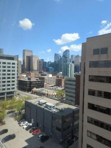 a view of a city with cars parked in a parking lot at Stylish Downtown Calgary Home in Calgary
