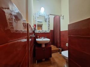 a bathroom with a sink and a mirror at Passione Romana Apartment in Rome