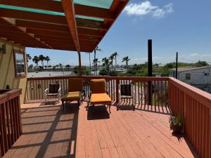 a patio with chairs and awning on a deck at Southwind Inn in Port Isabel