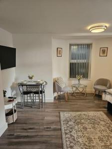 a living room with a table and a dining room at ZenZone Studio Flat in Preston