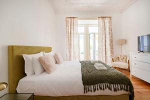 Postel nebo postele na pokoji v ubytování Lisbon Lodge
