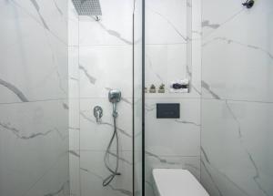 a white bathroom with a shower and a toilet at La Vie Villa in Zakynthos Town +38 photos