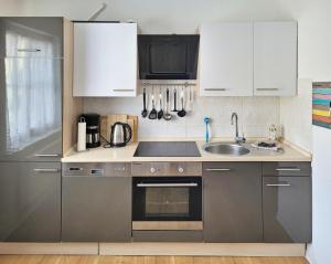 a kitchen with white cabinets and a sink at Ferienwohnung Seebrise in Sassnitz