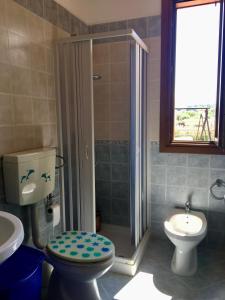a bathroom with a shower and a toilet and a sink at Villino Giulia in Altavilla Milicia
