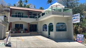 a large white house with a sign in front of it at Royal Pacífico Manzanillo in Manzanillo
