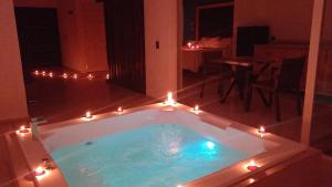 a bath tub with candles and lights in a room at Hotel Posada Huasteca in Tamazunchale