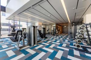 a gym with treadmills and weights in a building at Luxury Home in Hollywood with Pool I Gym I Free Parking in Los Angeles