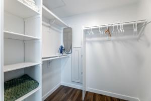 a white walk in closet with white shelves at Luxury Home in Hollywood with Pool I Gym I Free Parking in Los Angeles