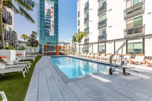 an outdoor swimming pool in a building with lounge chairs at Luxury Home in Hollywood with Pool I Gym I Free Parking in Los Angeles