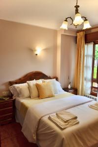 a bedroom with a large bed with towels on it at Casa Marian in Cangas de Onís