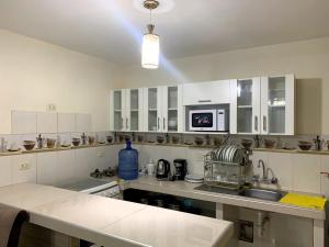 a kitchen with white cabinets and a counter top at DEPARTAMENTO con COCHERA en Chimbote in Chimbote