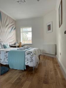a bedroom with a bed and a table in it at Rosie Cosy House Cricklewood in London