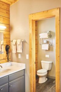 a bathroom with a toilet and a sink at Lakeside Lodge Resort and Marina in Pinedale