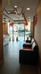 a lobby with couches and red decorations in a building at The Patioz Boutique Hotel in Kajang