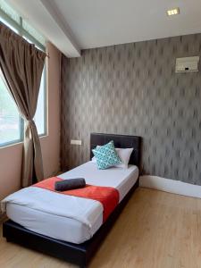 a bedroom with a bed in a room with a window at The Patioz Boutique Hotel in Kajang