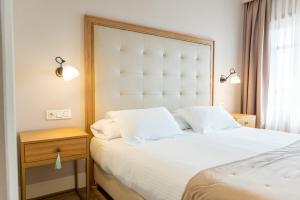 Postel nebo postele na pokoji v ubytování Hotel Boutique ADOLFO