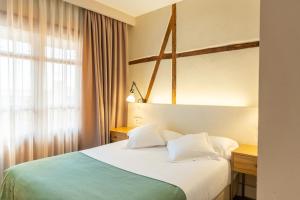 Postel nebo postele na pokoji v ubytování Hotel Boutique ADOLFO