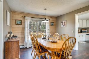 a dining room with a wooden table and chairs at Over Andover Retreat with Hot Tub Walk to Lake! in Andover