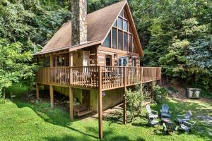 a large wooden house with a wrap around deck at NEW! Black Bear Chalet Getaway with Games, Hot Tub, RnR, Fun in Sevierville