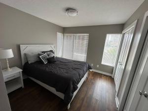 a bedroom with a bed with a black comforter at Luxury Downtown Townhome Unit 14 in Cleveland