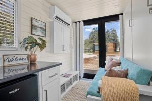 a person laying on a couch in a tiny house at New! Luxury Shipping Container The Desert Escape in Fredericksburg