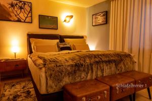 a bedroom with a large bed with a night stand at GORI Boutique Apartments – Tirol in Reutte