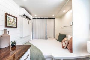 a small bedroom with a bed and a desk at New! Luxury Shipping Container The Desert Escape in Fredericksburg