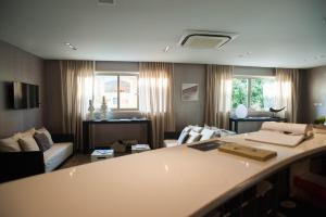 a living room with a couch and a table at FerroHotel in Modica