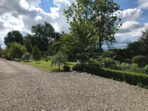 a gravel driveway with a garden in the background at The Garden Tent in Whitchurch