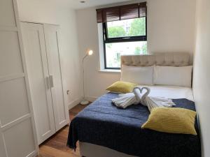 a bedroom with a bed with a bow on it at City Center Camden Market Budget Apartment and Rooms in London