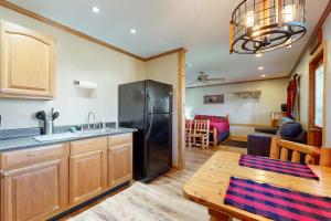 a kitchen with a black refrigerator and a table at Blue Line Resort Cabin #1 in Carbondale