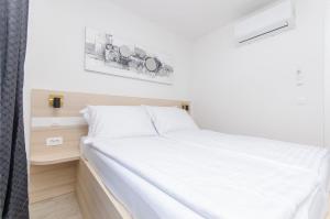 Una cama en una habitación con un colchón blanco en Apartments Villa V2, en Vir 59 fotos más