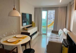 a living room with a couch and a table at Conforto Na Melhor Localização Com Vista Mar in São Luís