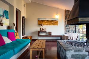 a living room with a couch and a table at La Pedra Hotel Boutique, Raco in Raco