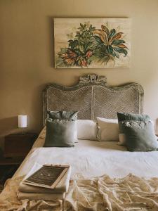 a bedroom with a bed with a book on it at La Pedra Hotel Boutique, Raco in Raco