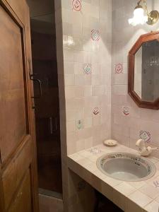 a bathroom with a sink and a mirror at Relais Courmayeur - Fiore di bosco - Mont Blanc - Italia in Courmayeur