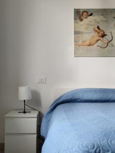 a bedroom with a bed and a painting on the wall at HomeLame 57 in Bologna