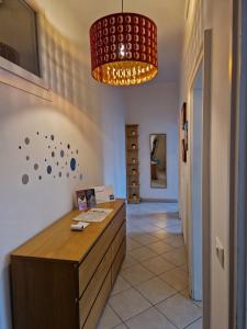a room with a desk and a chandelier at HomeLame 57 in Bologna