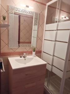 a bathroom with a sink and a shower with a mirror at Ca l'Èndula II in Lucena del Cid +30 photos