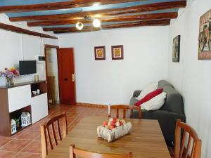 a living room with a table and a couch at Ca l'Èndula II in Lucena del Cid