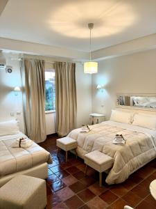 a bedroom with two beds and a window at La Magnolia 140 in Fiumicino
