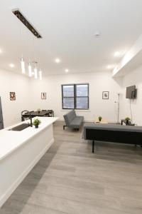 a living room with a couch and a table at Modern Contemporary 2-Bed Apt Close to NYC in Bayonne