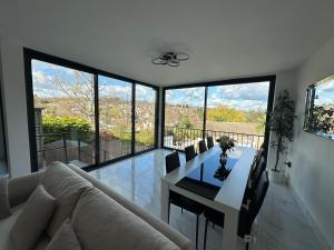 a living room with a couch and a dining room table at Luxurious & Elegant 6-Bed House in Barnet