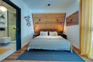 a bedroom with a large bed with a wooden headboard at Villa Bellis in Mrkopalj