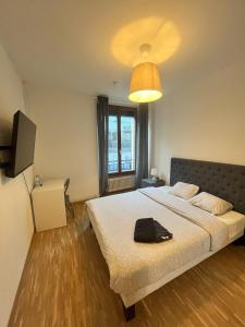 una camera da letto con un letto con una borsa nera sopra di Residence Geneva Quartier de Plainpalais a Ginevra