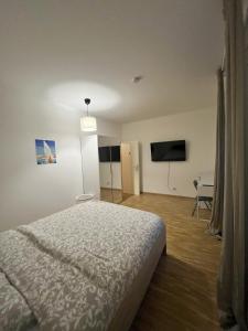 a bedroom with a bed and a flat screen tv at Residence Geneva Quartier de Plainpalais in Geneva